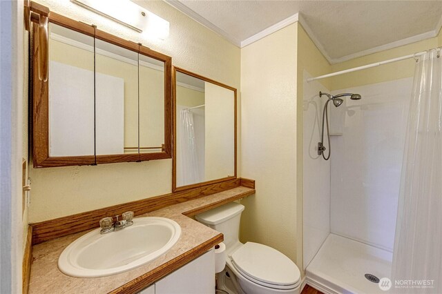 5611 128th Pl SE, Everett, WA 98208 - full bathroom featuring ornamental molding, toilet, vanity, a shower with curtain, and a textured wall