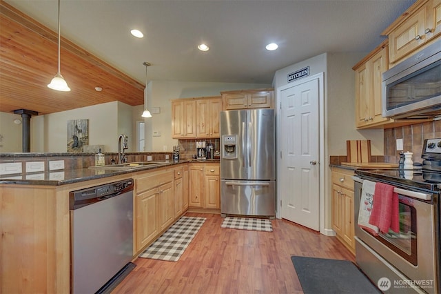 1510 E Benson Lake Dr, Grapeview, WA 98546 - kitchen featuring appliances with stainless steel finishes, a sink, light brown cabinetry, backsplash, and lofted ceiling