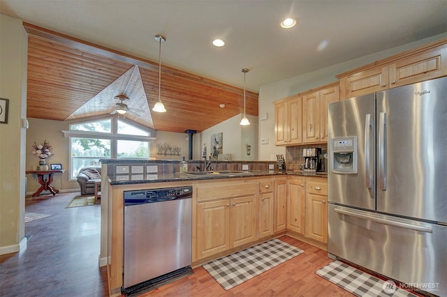 1510 E Benson Lake Dr, Grapeview, WA 98546 - kitchen with stainless steel appliances, a sink, light brown cabinetry, light wood finished floors, and lofted ceiling