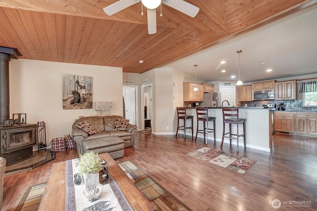 1510 E Benson Lake Dr, Grapeview, WA 98546 - living room with a wood stove, wood finished floors, ceiling fan, recessed lighting, and wooden ceiling