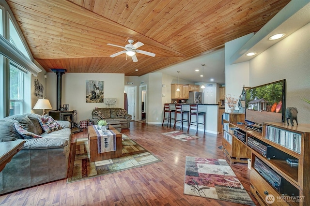 1510 E Benson Lake Dr, Grapeview, WA 98546 - living room featuring a wood stove, vaulted ceiling, wood ceiling, a ceiling fan, and recessed lighting