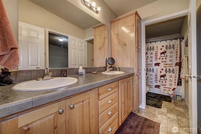 1510 E Benson Lake Dr, Grapeview, WA 98546 - full bathroom featuring double vanity, toilet, stone finish flooring, and a shower with curtain
