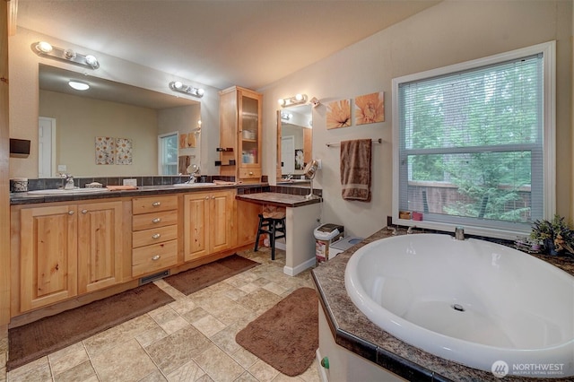 1510 E Benson Lake Dr, Grapeview, WA 98546 - full bathroom with a sink, a bathtub, and stone finish flooring
