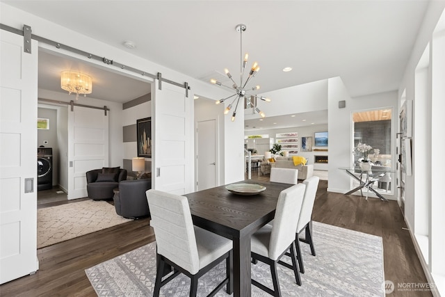 6720 Soundview Dr NE, Tacoma, WA 98422 - dining area featuring a barn door, washer / dryer, a chandelier, dark wood-style flooring, and recessed lighting