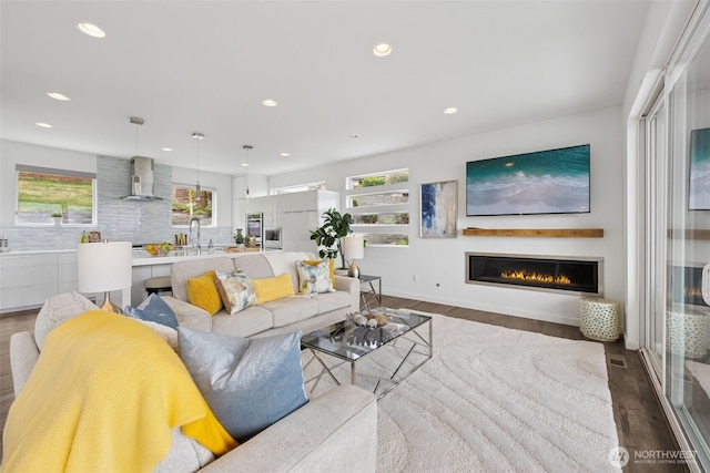 6720 Soundview Dr NE, Tacoma, WA 98422 - living room with recessed lighting, dark wood-type flooring, and a glass covered fireplace