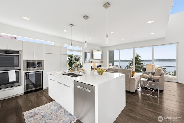 6720 Soundview Dr NE, Tacoma, WA 98422 - kitchen featuring appliances with stainless steel finishes, beverage cooler, modern cabinets, healthy amount of natural light, and recessed lighting