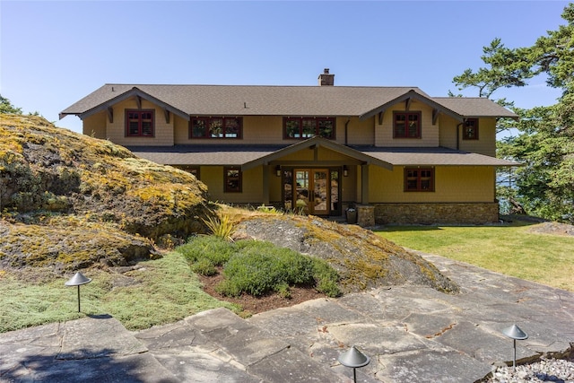 481 Grimes Riker Ln, Lopez Island, WA 98261 - view of front of house with french doors, a chimney, a front yard, and stone siding