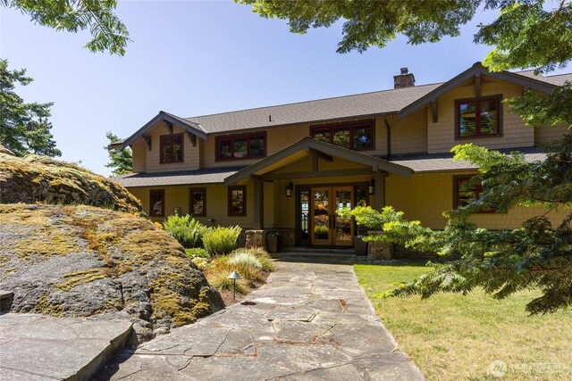 481 Grimes Riker Ln, Lopez Island, WA 98261 - view of front of house with a chimney, french doors, a shingled roof, and a front yard
