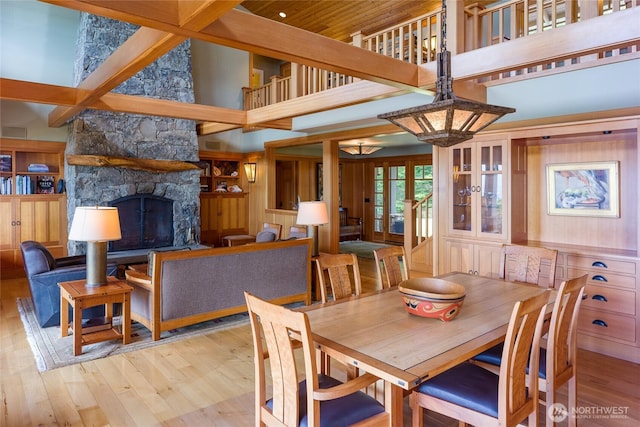481 Grimes Riker Ln, Lopez Island, WA 98261 - dining room with a towering ceiling, wood finished floors, and a stone fireplace