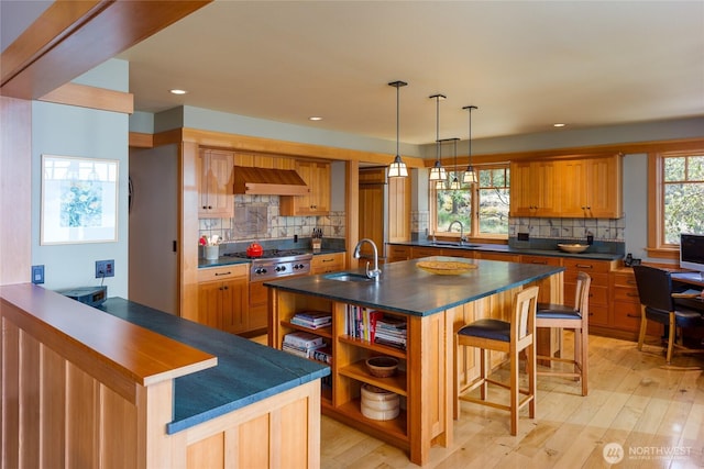 481 Grimes Riker Ln, Lopez Island, WA 98261 - kitchen featuring open shelves, a sink, a kitchen bar, stainless steel gas cooktop, and dark countertops