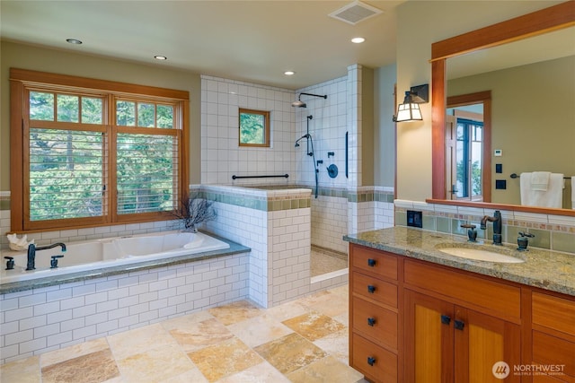 481 Grimes Riker Ln, Lopez Island, WA 98261 - bathroom with a garden tub, a tile shower, vanity, recessed lighting, and tile walls
