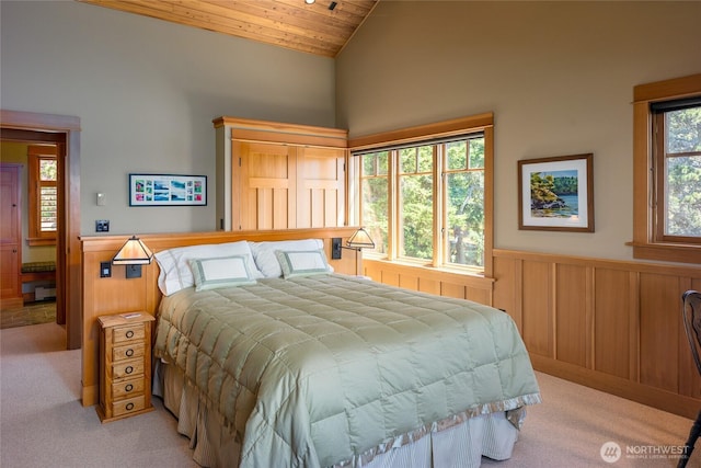 481 Grimes Riker Ln, Lopez Island, WA 98261 - bedroom featuring light carpet, wainscoting, vaulted ceiling, and wood ceiling