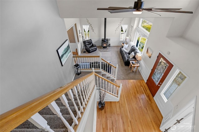 11024 127th Ave NE, Lake Stevens, WA 98258 - stairs with a towering ceiling, a wood stove, wood finished floors, and ceiling fan