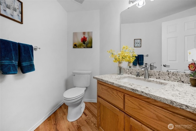 11024 127th Ave NE, Lake Stevens, WA 98258 - bathroom featuring wood finished floors, toilet, vanity, and baseboards