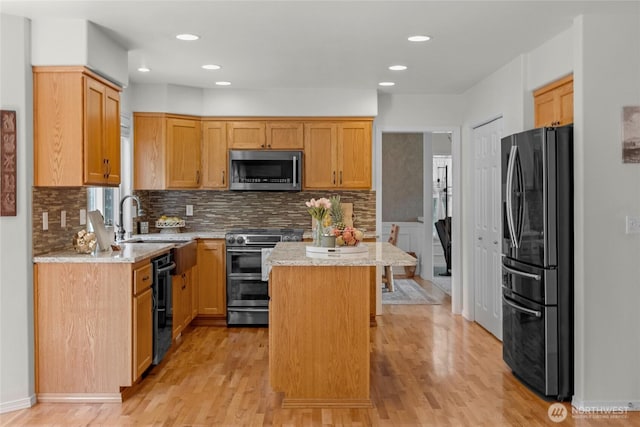 11024 127th Ave NE, Lake Stevens, WA 98258 - kitchen featuring appliances with stainless steel finishes, light wood-style flooring, a sink, backsplash, and a center island