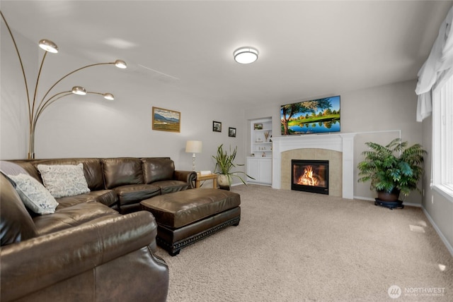 11024 127th Ave NE, Lake Stevens, WA 98258 - carpeted living area featuring a tiled fireplace, built in shelves, and baseboards