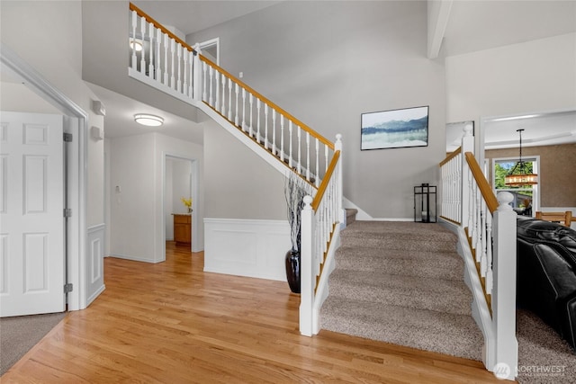 11024 127th Ave NE, Lake Stevens, WA 98258 - stairs with wood finished floors, a towering ceiling, a wainscoted wall, a decorative wall, and a chandelier