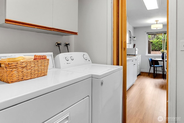21120 77th Pl W Unit 104, Edmonds, WA 98026 - laundry room featuring cabinet space, light wood-style flooring, and separate washer and dryer