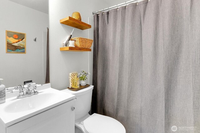 21120 77th Pl W Unit 104, Edmonds, WA 98026 - bathroom featuring toilet, vanity, and a shower with curtain