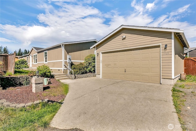 7725 203rd Street Ct E Unit 27, Spanaway, WA 98387 - view of front of house featuring a garage, an outdoor structure, and driveway