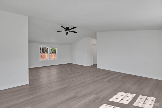 7725 203rd Street Ct E Unit 27, Spanaway, WA 98387 - unfurnished living room with a ceiling fan, vaulted ceiling, wood finished floors, and baseboards