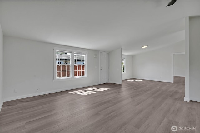 7725 203rd Street Ct E Unit 27, Spanaway, WA 98387 - unfurnished living room with wood finished floors and baseboards