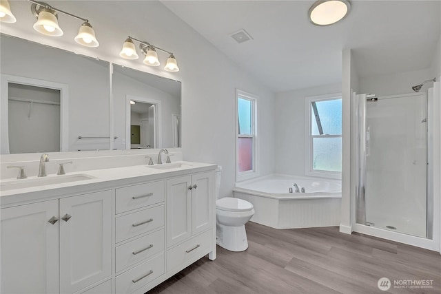 7725 203rd Street Ct E Unit 27, Spanaway, WA 98387 - full bathroom featuring a stall shower, double vanity, wood finished floors, a bath, and toilet