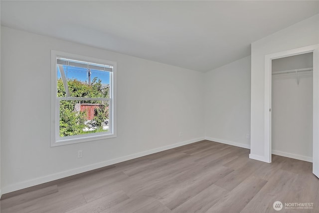 7725 203rd Street Ct E Unit 27, Spanaway, WA 98387 - unfurnished bedroom with wood finished floors, baseboards, and a closet