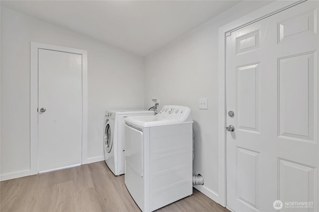 7725 203rd Street Ct E Unit 27, Spanaway, WA 98387 - laundry room with washer and dryer, light wood-type flooring, and baseboards