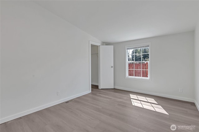 7725 203rd Street Ct E Unit 27, Spanaway, WA 98387 - unfurnished room featuring wood finished floors, baseboards, and lofted ceiling