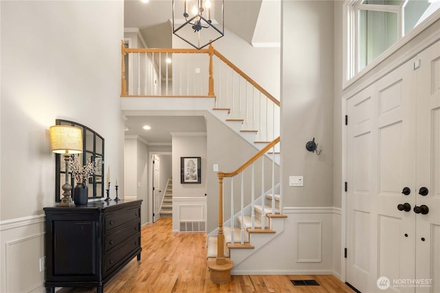 25819 NE 9th St, Sammamish, WA 98074 - foyer with stairs, a chandelier, a high ceiling, wood finished floors, and a decorative wall