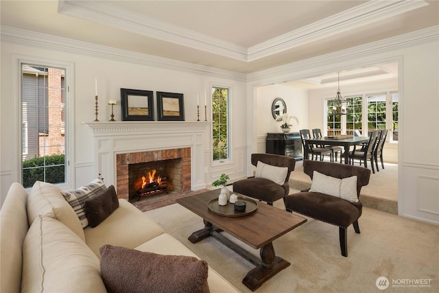 25819 NE 9th St, Sammamish, WA 98074 - living area featuring a tray ceiling, ornamental molding, a brick fireplace, and light carpet