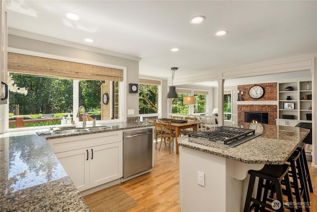 25819 NE 9th St, Sammamish, WA 98074 - kitchen with stainless steel appliances, ornamental molding, open floor plan, light stone countertops, and recessed lighting