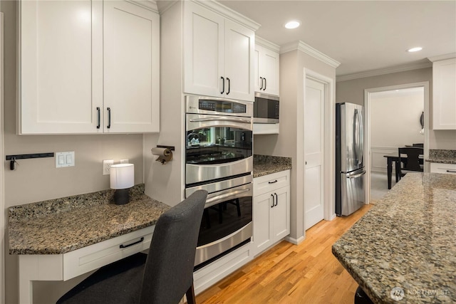 25819 NE 9th St, Sammamish, WA 98074 - kitchen with stainless steel appliances, ornamental molding, white cabinetry, light wood-style flooring, and dark stone counters