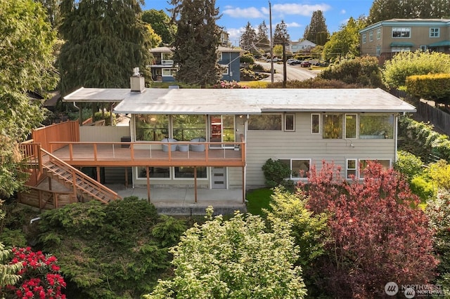 10762 Exeter Ave NE, Seattle, WA 98125 - back of property featuring a wooden deck, a patio area, stairs, and a chimney