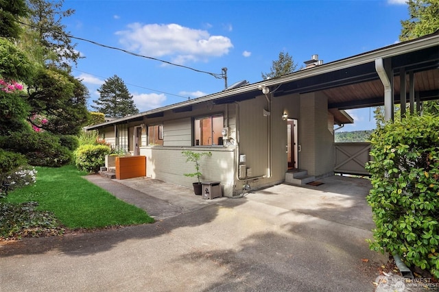 10762 Exeter Ave NE, Seattle, WA 98125 - view of side of home with a yard, a patio, and brick siding