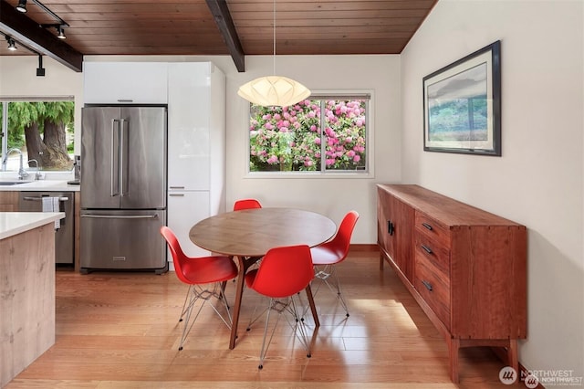 10762 Exeter Ave NE, Seattle, WA 98125 - dining space with light wood-type flooring and wooden ceiling with exposed beams