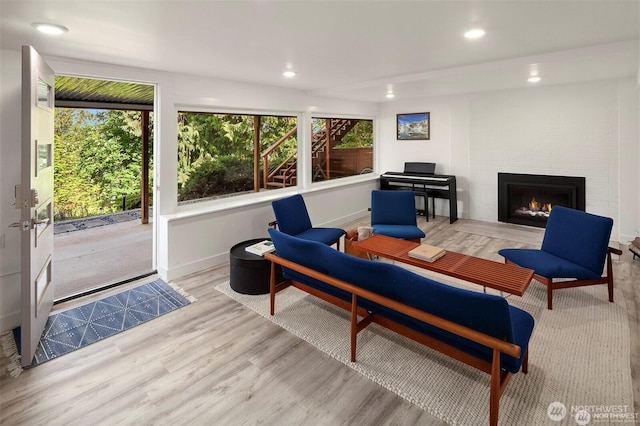 10762 Exeter Ave NE, Seattle, WA 98125 - living area featuring wood finished floors, a fireplace, recessed lighting, and baseboards