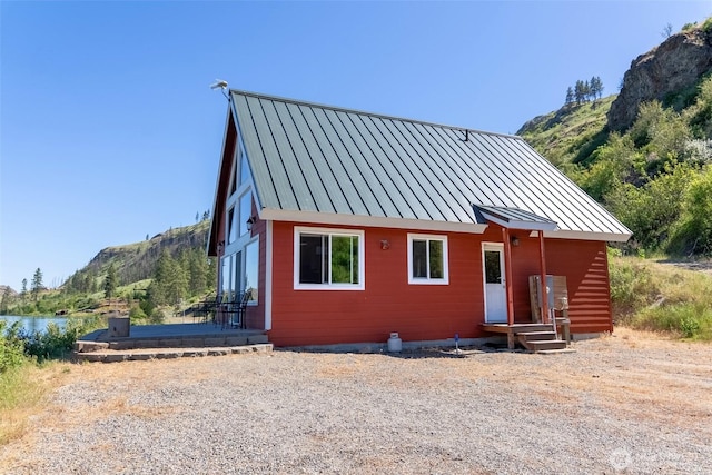 58 Alkali Cuttoff Rd, Riverside, WA 98849 - view of front facade featuring a standing seam roof, metal roof, and a water and mountain view