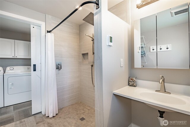 5691 Nakat Way, Blaine, WA 98230 - bathroom with a sink, washing machine and clothes dryer, and tiled shower