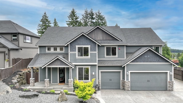 25625 SE Olympic Ln, Black Diamond, WA 98010 - craftsman inspired home with a porch, driveway, a shingled roof, and stone siding