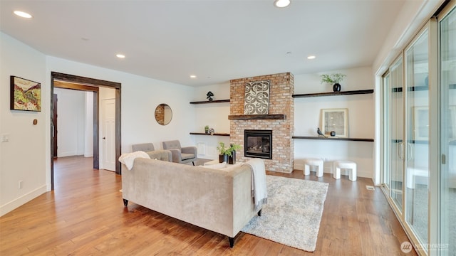 25625 SE Olympic Ln, Black Diamond, WA 98010 - living room with wood finished floors, plenty of natural light, a brick fireplace, recessed lighting, and baseboards