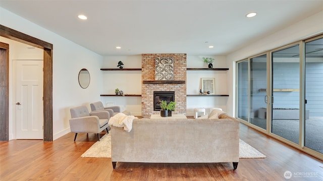 25625 SE Olympic Ln, Black Diamond, WA 98010 - living area featuring wood finished floors, a brick fireplace, recessed lighting, and baseboards