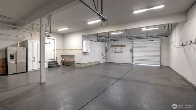 25625 SE Olympic Ln, Black Diamond, WA 98010 - garage featuring stainless steel refrigerator with ice dispenser and a garage door opener