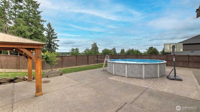 25625 SE Olympic Ln, Black Diamond, WA 98010 - view of swimming pool with a fenced backyard and a patio