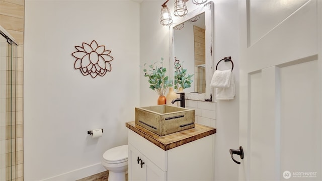 25625 SE Olympic Ln, Black Diamond, WA 98010 - bathroom with toilet, tasteful backsplash, a shower with door, vanity, and baseboards
