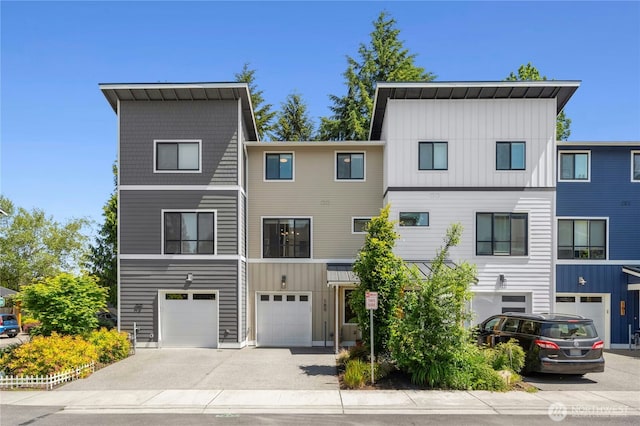 189 Countryman Dr, Monroe, WA 98272 - view of front facade with board and batten siding, driveway, and a garage
