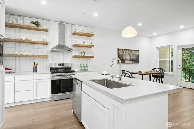 189 Countryman Dr, Monroe, WA 98272 - kitchen with wall chimney range hood, appliances with stainless steel finishes, a sink, open shelves, and backsplash