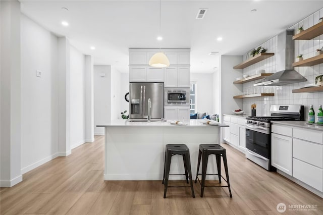 189 Countryman Dr, Monroe, WA 98272 - kitchen featuring appliances with stainless steel finishes, open shelves, backsplash, light wood-style floors, and a sink