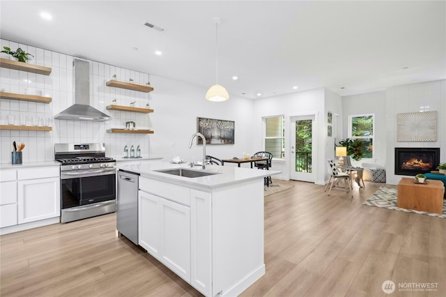 189 Countryman Dr, Monroe, WA 98272 - kitchen featuring wall chimney exhaust hood, stainless steel appliances, open shelves, open floor plan, and a sink